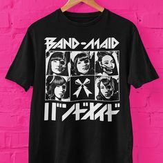 Band-Maid skull faces graphic t shirt. Makes a great gift for J-pop fans, Band-Maid rock fans.  Bella+Canvas 3001 * 100% Air Lume combed and ring spun cotton (fiber content may vary for different colors) * Light fabric (4.2 oz/yd² (142 g/m * Retail fit * Tear away label * Runs true to size With side seams Located along the sides, they help hold the garment's shape longer and give it structural support Shoulder tape Twill tape covers the shoulder seams to stabilize the back of the garment and pre Pop Culture Graphic Print Shirt For Concerts, Halloween Concert T-shirt With Screen Print, Pop Culture Screen Print Tops For Concerts, Band Merch Shirt With Graphic Print For Concerts, Pop Culture Graphic Print T-shirt For Concert, Black Pop Culture Top For Concert, Band Merch Graphic Tops For Concerts, Band Merch Tops With Graphic Design For Concerts, Band Merch Graphic Design Tops For Concert