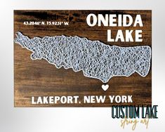 a wooden sign with the words oneida lake on it and a heart in the middle