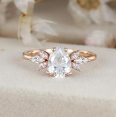 an engagement ring with a pear shaped diamond in the center