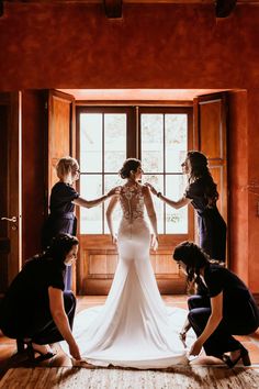 the bride is getting ready to walk down the aisle with her bridal gown on