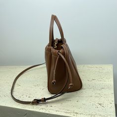 MiNi Shopping Bag CABAS TRIOMPHE Small Smooth Cow Leather Drawstring Bag
9 X 7 X 6 inches (22 X 17 X 15 cm)
Cow leather
Suede cowhide lining
Hand-carry, shoulder and cross-body
Decorative drawstring
POIGNÉES (FLÈCHE : 12.5 CM)
Removable and adjustable shoulder strap, minimum length 18 inches (45 cm), maximum length 21 inches (54 cm) Celine Cabas, Mini Shopping Bag, Leather Drawstring Bags, Small Drawstring Bag, Lv Purse, Lv Shoes, Lv Handbags, Black Leather Handbags, Lv Belt