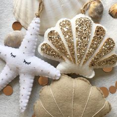 sea shells and starfish ornaments are on the beach