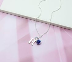 A highly personalised necklace with a genuine blue Sapphire gemstone birthstone charm and a 925 Sterling Silver letter threaded onto delicate 925 Sterling Silver chain. Sapphire is the traditional September Birthstone. Delicate, dainty and pretty, this makes the perfect favourite everyday necklace, and a lovely personalised gift for anyone with a September birthday or who simply loves Sapphire. - All parts solid 925 Sterling Silver - Birthstone charm features a genuine natural Sapphire gemstone Sterling Silver Birthstone Necklace With Initial Pendant For Her, Blue Sterling Silver Birthstone Necklace As Gift, Personalized Blue Birthstone Necklace As Gift, Blue Sterling Silver Birthstone Necklace For Gifts, Blue Initials Jewelry As A Gift, Anniversary Necklace With Lab-created Sapphire Birthstone, Elegant Birthstone Necklace With Lab-created Sapphire, Sterling Silver Initial Pendant Charm Necklace With Gemstone, Silver Birthstone Necklace With Gemstone Initial Pendant