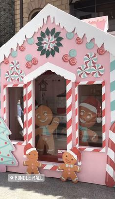 a large pink and white building with gingerbreads on it