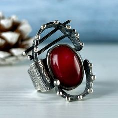 Handmade sterling silver ring with natural red coral stone. Red stone ring for women and girls. Oval shape ring with red color gemstone. Armenian handmade jewelry by Shahinian Family. This Unusual ring seems to come from  Space) If you are fond of unique and exclusive jewelry, this set can be a great idea. Be different Give and get only high-quality, not mass-produced, and unique jewelry. Your jewelry introduces you before you even speak  FULL DETAILS】 ► Gemstone: Natural red coral cabochon ► RING size: all sizes are available (choose from the option) ► Ring Weight: approx. 12 gr ► Earrings weight: approx. 13 gr ►Earrings length without hook: 34 mm (with hook 52 mm) ► Stone size: 10 mm / 8 mm More from us For more gemstone rings, click here: https://etsy.me/3s2cHOi For more earrings, click Handmade Red Sterling Silver Rings, Handmade Red Oval Cabochon Jewelry, Red Oval Rings With Natural Stones, Red Sterling Silver Ring With Natural Stones, Artisan Red Sterling Silver Rings, Red Sterling Silver Rings With Natural Stones, Red Oval Moonstone Ring, Unique Oval Ruby Ring With Stone Setting, Artisan Red Ring For Gift