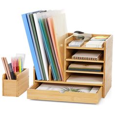 a wooden desk organizer with drawers filled with files and folders on it's sides