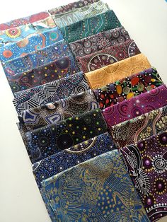 a close up of many different colored ties on a table