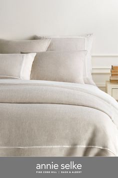 an image of a bed with white linens