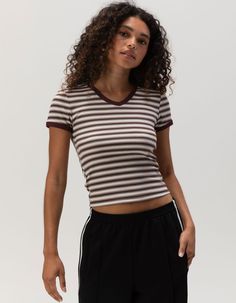 Full Tilt V-Neck Baby Tee. Ribbed Knit Construction. Allover Stripe Print. V-Neckline. Short Sleeve. Shrunken Fit. 57% Cotton, 38% Polyester, 5% Spandex. Machine Wash. Imported. Model Is Wearing A Size Small. Model Measurements:height: 5'7" Bust: 32cwaist: 24"hips: 35"