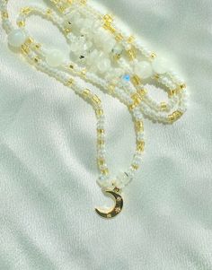 "Made to order gold and pearl white glass beads with moonstone crystals and a 14k gold filled moon charm! Removable and adjustable up to 2\" with a choice of silver or 14k gold clasp.  In the notes please include what length you would like your beads! Measure your waist wherever you want your beads to fall as shown in the listing photo. Moonstone 🌙 is good for enhancing your intuition, balancing emotions, and inspires new beginnings. Custom waist beads are available through message or DM on Instagram! Chakras: Sacral, Crown All crystals are charged under moonlight of the new moons and cleansed with palo santo before they are mailed."