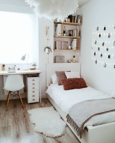 a small bedroom with white walls and wooden floors