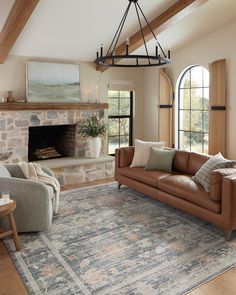 a living room filled with furniture and a fire place in the middle of an open floor plan