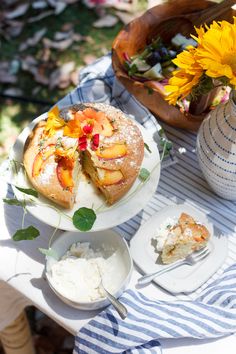 a cake on a table with flowers and plates