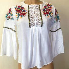 Available By Angela Fashion, Multi Color Floral Embroidered Girls Size Large (Women’s Size Small Fits) White Color Flared Sleeves Buttons Up Never Worn Beautiful And Great Condition Casual White Peasant Top For Festival, Traditional Spring Blouse With Machine Embroidery, Spring Long Sleeve Blouse With Multicolor Embroidery, Fall Vacation Embroidered Blouse, Spring Long Sleeve Peasant Top With Embroidered Hem, Floral Embroidered Tops For Spring Festival, Casual White Bell Sleeve Tops, Fitted White Top With Machine Embroidery, White Fitted Top With Machine Embroidery