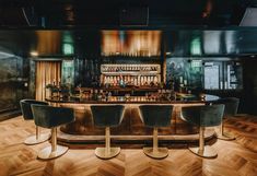 a bar with four stools in front of it