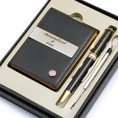 a pen and notebook in a box with writing on it