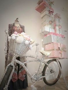 a bicycle is parked next to a stack of presents