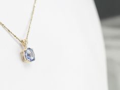 Blue Oval Pendant Necklace With Diamond Cut, Oval Blue Topaz Sapphire Necklace, Oval Tanzanite Jewelry With Gemstone Accents, Blue Oval Diamond Cut Necklace, Blue Oval Faceted Necklace, Blue Oval Faceted Necklaces, Oval Blue Diamond Cut Necklace, Fine Tanzanite Oval Pendant Jewelry, Oval Blue Topaz Necklace