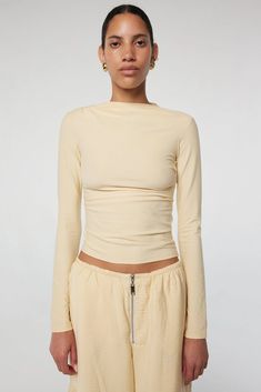 Selma: High neck, slim long sleeves in a cotton-modal blend. Effortless drape with hand-pleated details. 45% Cotton 45% Modal 10% Spandex. Versatile Long Sleeve Elastane Top, Versatile Long Sleeve Top With Soft Stretch, Stretch Modal Long Sleeve Tops, Versatile Soft Stretch Long Sleeve Top, Long Sleeve Tops With Minimal Stretch For Layering, Long Sleeve Tops For Layering With Minimal Stretch, Fitted Modal Long Sleeve Tops, Stretch Elastane Long Sleeve Top For Fall, Fitted Long Sleeve Modal Top