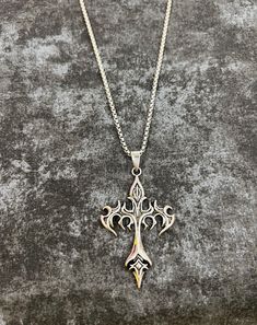 Ignite your style with our Flame Cross Gothic necklace, a captivating blend of dark allure and fiery elegance. This eye-catching piece features a striking silver chain that holds a bold cross pendant, intricately detailed with flame motifs that evoke both intensity and passion. The pendant's dark, burnished finish is contrasted by the gleaming silver highlights, creating a dramatic effect that catches the eye from every angle. Designed for those who embrace gothic sophistication with a touch of Grunge Necklace, Silver Highlights, Goth Necklace, Gothic Necklace, Cross Pendant Necklace, Gothic Jewelry, Just Girl Things, Cross Pendant, Vintage Necklace