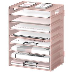 a pink shelf with many books and magazines on it's sides, all stacked together