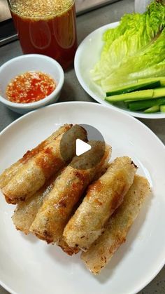 some food is on a white plate with sauce and lettuce in the background