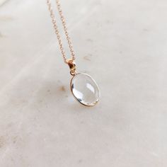 This stunning Pendant is set in 14k Solid Yellow Gold with Natural Clear Quartz with utmost precision. It is a unique gemstone Pendant for nearly every occasion and is completely hassle-free jewelry. ITEM DETAILS: * GEM: Clear Quartz * GEM SIZE: 10X14 mm * GEM SHAPE: Oval * GEM WEIGHT: 6.92 carats * Gold Purity: 14KT * Gold Weight: 0.53 gram * Total Weight: 1.91 gram The Gold purity is guaranteed and it comes with authentic 14KT gold hallmark. Since my items are handmade, they are absolutely nickel and lead free. CUSTOMIZATION: * Gemstone customization is available and it can be substituted with a gem of your choice. Kindly message me for the same. PACKAGING * The Pendant comes with layers of safe and secure wrapping along with Free handmade jewelry box with every purchase. ➡️Head to these White Topaz Birthstone Jewelry For Anniversary, Clear Gemstone Pendant Jewelry, Elegant Necklace With Si Clarity Oval Pendant, Fine Jewelry White Topaz Gift, Elegant Oval Pendant Jewelry With Bezel Setting, Exquisite Bezel Set Jewelry Gift, Elegant Clear Necklace For Gift, Elegant Gemstone Necklace In Clear Color, Clear Round Gemstone Jewelry