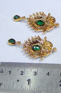 18 K solid gold Diamond and Emerald gemstone set earrings. Beautiful pair for your jewelry collection. Size -4/2 cm, weight of pair-13.390 grams, Diamond weight -2.82 carats, material -18 K solid gold , VS G diamond and natural Emerald. Yellow Gold Temple Jewelry Earrings For Anniversary, Anniversary Yellow Gold Temple Jewelry Earrings, Elegant Pendant Earrings With Stone Setting, Temple Jewelry Style Drop Earrings For Formal Occasions, Diamond Gemstone Earrings In Temple Jewelry Style, Diamond Gemstone Temple Jewelry Earrings, Temple Jewelry Diamond Gemstone Earrings, Temple Style Diamond Gemstone Earrings, Temple Jewelry Green Pendant Earrings