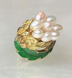 Pearl Leaf Ring, Pearl Bouquet Ring, Enamel Ring, Rare Vintage Pearls, Vintage Gold Ring, Floral Pearl Ring, Solid Gold Ring, Gift for Her This charming piece is a true work of art. Featuring a cluster of 8 elongated pearls arranged as a bouquet of flowers surrounded with solid gold and green enamel leaves set on an angle in 14k yellow gold. * Ring size in 6 3/4 Formal White Enamel Rings, Green Enamel Wedding Jewelry, Green Enamel Jewelry For Wedding, White Enamel Wedding Rings, Elegant White Enamel Wedding Ring, Elegant White Oval Enamel Ring, White Luxury Enamel Wedding Ring, Hallmarked Enamel Jewelry For Weddings, Wedding Fine Jewelry Enamel Ring