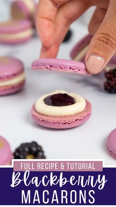 a person picking up some cookies from the table with berries and blueberries on it