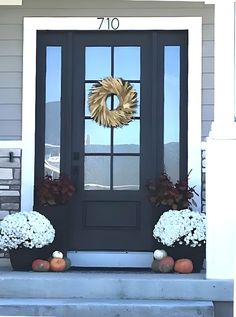 the front door is decorated with flowers and wreaths