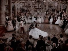 a group of people that are standing in the middle of a dance floor with dresses on