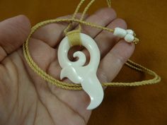 "(Internal #J-WHALE-2a)  You are bidding on a beautifully hand carved graceful Whale tail with Maori hook pendant Natural cow bone, flat on back; beautifully wrapped on top. Measures 2-1/2\" tall x 1-3/8\" wide x 1/4\" thick On 32\" adjustable natural cotton braided necklace with white cow bone sliding knot bead closure that can be adjusted to any length smaller.   These are stock photos. Other accepted payment: Credit card (Mastercard\\/Visa\\/Discover) inquire for details." White Adjustable Jewelry As Gift, Unique Carved White Necklace, Unique White Carved Necklace, Unique Adjustable White Jewelry, Unique Carved Bone Jewelry, Traditional Bone-colored Jewelry Gift, Traditional Bone-colored Jewelry As A Gift, Unique Bone-colored Carved Jewelry, White Jewelry With Adjustable Cord