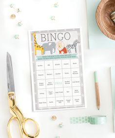 a printable baby shower game next to some crafting supplies on a white table