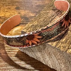 Experience the unique beauty and craftsmanship of our Handmade Boho Western Copper Native Sunflowers Narrow Bracelet. Each piece is skillfully crafted with intricate details and finished with a gift box, making it the perfect gift for any occasion. Add a touch of bohemian elegance to your style and embrace the warmth of the sunflowers. Check out my other listings for matching Wide Cuff Sunflowers Bracelet & Matching Dangle Earrings Adjustable, Ships in Gift Box, FAST shipping Handmade Brown Flower Jewelry, Artisan Rectangular Bracelets As Gifts, Artistic Flower-shaped Jewelry For Crafting, Adjustable Stamped Flower Jewelry, Handmade Brown Bracelets For Crafting, Bohemian Sunflower Jewelry As Gift, Bohemian Sunflower Jewelry For Gift, Bohemian Sunflower Design Jewelry As Gift, Artisan Stamped Brown Jewelry