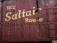 an old red train car with the words the saltai roule painted on it