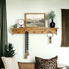 a living room filled with furniture and decor on top of a wooden shelf next to a window