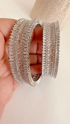 Rhodium Finish American Diamond/CZ Bangles/Bracelet/Indian Party Wear Bangles/ CZ stone bangles/Indian wedding/bridal jewelry Plating-Rhodium Finish Opening :Not a  Screw type It is made by our artisans using expert techniques, so it sparkles and shines over the years. Best gift option for your loved ones comes in an exquisite gift box. Hand-set Metal Bangle For Parties, Silver Hoop Earrings With Sparkling Stones For Wedding, Hand Set Metal Bangle For Parties, Wedding Hoop Earrings With Bling And Cubic Zirconia, Diamond Cut Bangle Bracelets For Party, Party Bangle Bracelet With Diamond Cut, Silver Diamond Cut Bracelet For Party, Crystal Hoop Jewelry For Weddings, Festive Sparkling Silver Jewelry