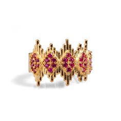 Ruby Stone & Gold Crown Adjustable Statement Ring, a luxurious and elegant piece designed to add a touch of royalty to your style. Crafted from 24k gold-plated brass, this stunning ring features geometric crown-like lines adorned with delicate ruby stones, creating a refined yet striking effect. The intricate design captures a regal aesthetic, making it both a sophisticated and eye-catching accessory. With its adjustable band, this ring offers versatility and comfort, making it perfect for any occasion Details Crafted with high-quality brass and plated with 24k gold for a luxurious finish. Ruby stone Adjustable size Avoid contact with chemicals, makeup, perfume. Do not use dips or abrasive cleaners on ring. To clean and brighten it up your ring, wipe them gently with jewelry polishing clot Luxury Gold-tone Brass Rings, Gold Ruby Ring With 17 Jewels For Wedding, Elegant 22k Gold Ring For Festive Occasion, Adjustable Elegant Ring For Festive Occasions, Elegant Adjustable Rings For Festive Occasions, Opulent Yellow Gold Jewelry With Gemstone, Regal Gold Rings For Formal Occasions, Opulent Yellow Gold Gemstone Jewelry, Yellow Gold Jeweled Rings As Gifts