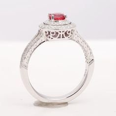 Deep and fiery red, this spinel is an absolute charm. The rings elegant design has two halos of pave set diamonds that extend out onto the shoulders of the ring. Handcrafted in 14K white gold with intricate filigree work just under the crown, she will wear this ring with pride. Order online info@jupitergem.com Rings Elegant, Red Spinel, Burma Myanmar, Spinel Gemstone, Detailed Ring, Fiery Red, 14k White Gold Ring, White Gold Ring, Natural Red