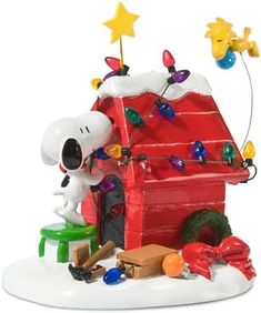 a charlie brown christmas ornament on a white surface with stars and decorations around it