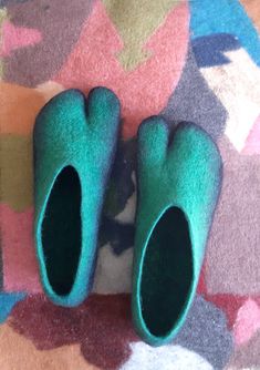 Aqua - tabi slippers wet felted minimalist unisex designer glove shoes made to order Order your own pair of felt slippers with your preferred colors and form. Please contact me to discuss the size and all other details. Cozy, warm tabi felt slippers in aquamarine color.  Felt keeps the heat of your body inside but does not add much extra warmth, so it regulates the temperature inside. Felt slippers are amazingly comfortable - lightweight and flexible, you do not even feel them when walking! After a short wear they will take the shape of your feet, they also get a little bit wider, so you don't need to buy a size bigger than your size. I highly recommend to wear felt slippers barefoot, because wool items have great healing properties, they can cure joint pain and have a little massage effec Tabi Slippers, Aquamarine Color, Felt Slippers, Aquamarine Colour, Felted Slippers, Healing Properties, Hungary, The Heat, Slippers