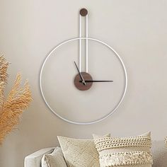 a living room filled with furniture and a large clock on the wall above it's head