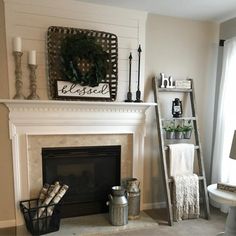 a living room filled with furniture and a fire place in front of a white fireplace