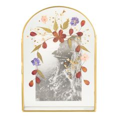 an ornate gold frame with flowers and leaves on the front, along with a white background