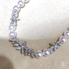 Highlight: Rare Japanese Akoya Rin Color Level Product Information Origin Japan MaterialAkoya Pearl, 18k Gold, and Diamond DimensionsNecklace Length 40-45 cm Adjustable Pearl Shaped: Round Size: 5.5-6 mm Quality: AAA Nacre: Very Thick Color: Rose Overtone Luster: Aurora Accessories Metal: 4.2 g of 18k White Gold Other: 0.46 ct of SI Quality Natural Diamond Wedding Akoya Pearl Necklaces With Brilliant Cut, Diamond White Akoya Pearl Necklaces For Wedding, Wedding Akoya Pearl Necklace With Brilliant Cut, White Akoya Pearl Diamond Necklace For Wedding, Diamond Pearl Necklace For Wedding, Akoya Pearl Diamond Necklace For Wedding, Elegant Round Pearl Necklace Hand Set, Elegant Hand Set Round Pearl Necklace, Wedding Single Strand Diamond Pearl Necklace