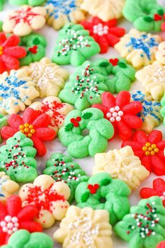 decorated cookies are arranged on a white surface