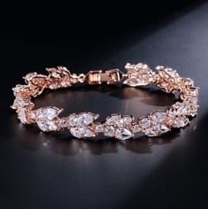 A classy bracelet for the modern bride! Featuring faceted cubic zirconia that catch the light from every angle, the bracelet is rhodium / 14K rose gold / 14K yellow gold plated for a flawless finish which perfectly enhances the intricate detailing and conveys a modern take on old elegance. The bracelet measures 0.5" wide (approx. 15mm) and 7" long (approx. 18cm). Closure is a secure fold-over clasp. Choose between Silver, Rose Gold and Yellow Gold finishes. To make your choice, select from the d Crystal Earrings Wedding, Bridal Earrings Drop, Cz Bracelet, Bride Earrings, Crystal Bangle, Leaf Jewelry, Bridal Bracelet, Zirconia Earrings, Swarovski Earrings