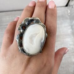 Large white agate ring Sterling silver, Druzy agate geode rings for women, Big ring asymmetric, white gemstone ring made in Armenia A huge and large ring in sterling silver 925 for women. The ring`s stone is natural druzy agate. One of a kind ring for unique women) The ring is absolutely handmade. All our jewelry is crafted with great attention to detail! We strive to provide you the best quality, modern design, and perfect look!! All our jewelry is made of high-quality sterling silver and is st Elegant Rings With Raw Stone, Round Shape, Elegant Raw Stone Wedding Rings, Elegant Wedding Rings With Raw Stone, Elegant Ring With Raw Stone, Agate Open Ring Jewelry, Agate Gemstone Open Ring Jewelry, Oval Agate Gemstone Crystal Ring, Elegant Adjustable Agate Rings, Oval Agate Crystal Ring With Gemstone