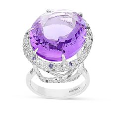 Exuding pure elegance, you'll stand out in a crowd with this romantic, feminine, luxurious designer jewelry piece. This stunning cocktail ring is crafted in 18K white gold,  showcasing an oval royal purple amethyst mounted in a six prong setting and wrapped in a gorgeous embellished diamond pave halo. The center stone sits on a white gold band in a cathedral setting featuring sparkling miniature diamond adorned filigree detailing. Surprise your loved Luxury Hallmarked Amethyst Ring For Formal Occasions, Luxury Purple Jewelry With Halo Detail, Luxury High Luster Purple Jewelry, Luxury Purple Rose Cut Diamond Jewelry, Elegant Green Amethyst Ring, Luxury Purple Amethyst Ring With Halo Setting, Luxury White Gold Amethyst Ring With Gemstone Accents, Exquisite Oval Amethyst Ring For Formal Occasions, Elegant White Gold Amethyst Ring With Center Stone